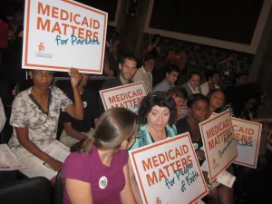 Protesters opposing Medicaid cuts, with signs reading "Medicaid Matters"