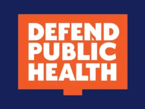 Logo for Defend Public Health. It has a blue background with an orange sign shape that says "defend public health" in white. 